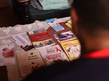 Ruth Mlambo looking at some of the HIV and AIDS pamphlets inside her house in Matika village in Muta