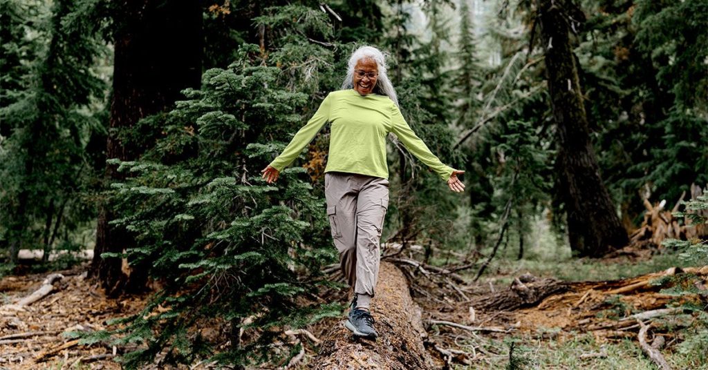 senior woman walking tree trunk 1200 628 facebook