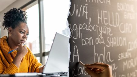 woman working laptop language chalkboard