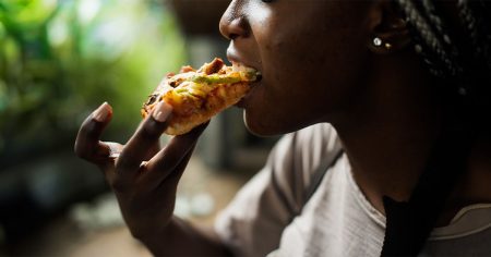 young woman eating pizza 1200 628 facebook