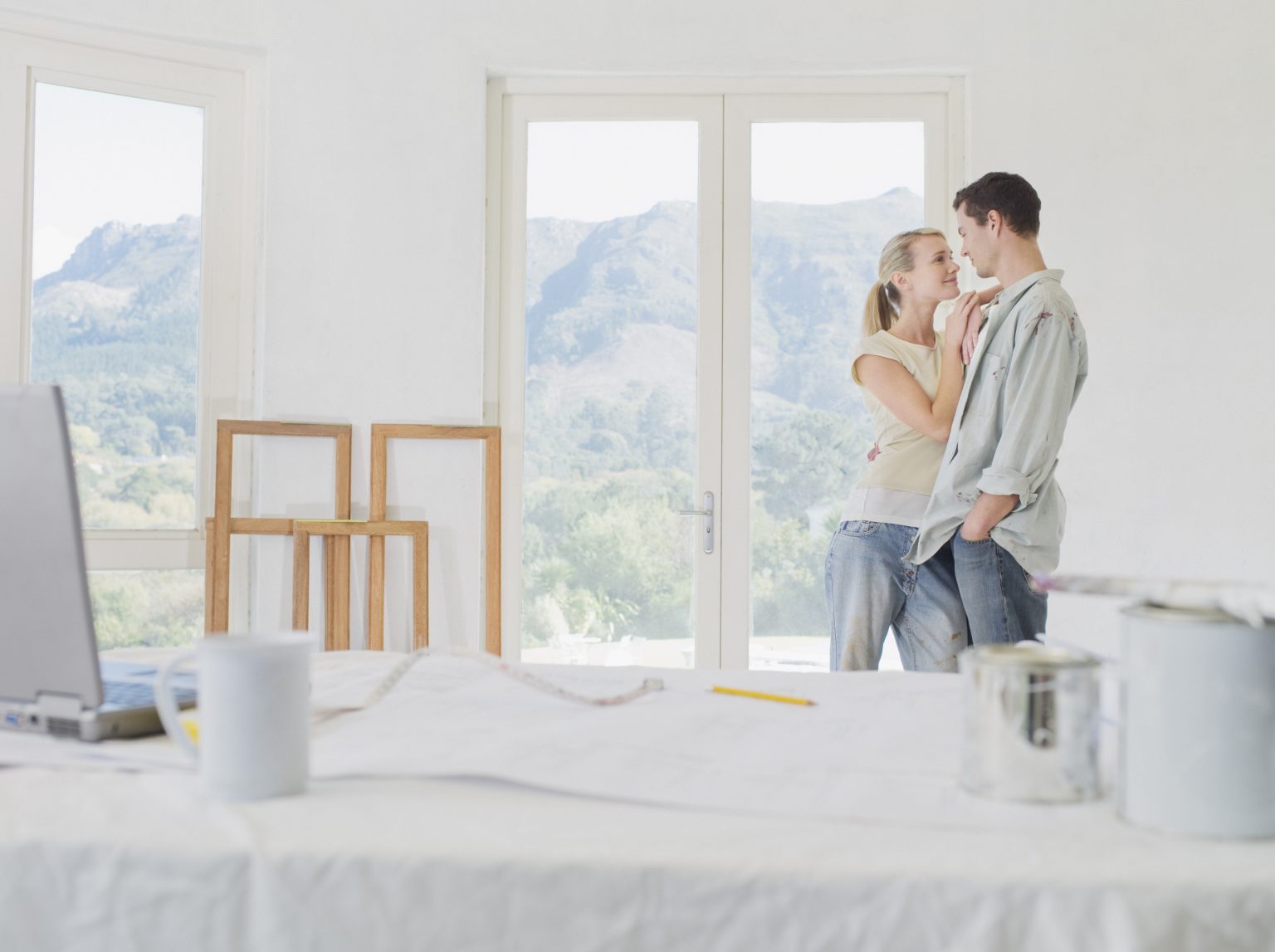 couple embracing empty home