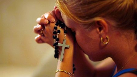 e0f00ebb Hands praying with rosary GettyImages e1667943420819