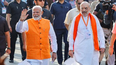 indias prime minister narendra modi l walks alongside amit shah