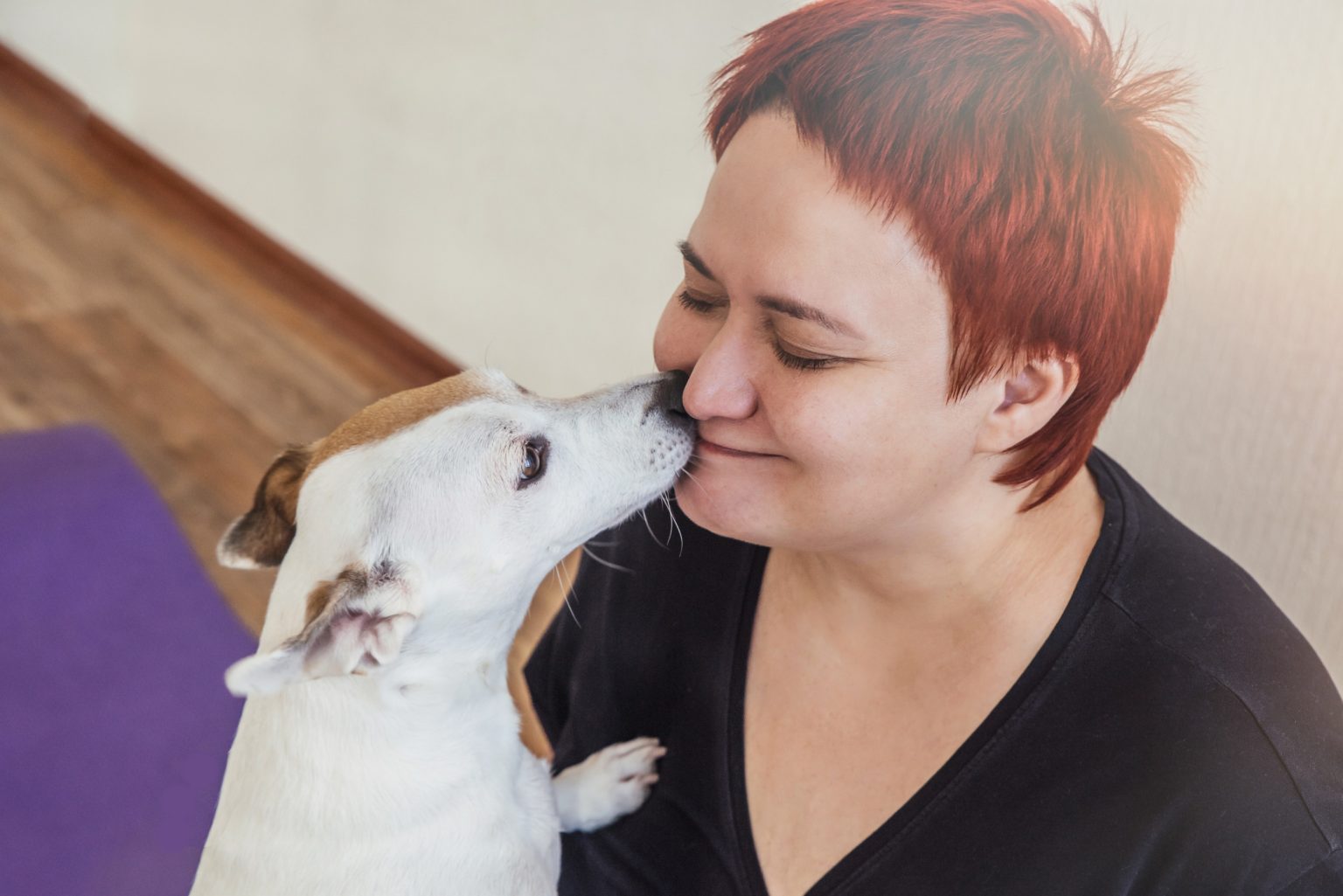 dog kissing womans face