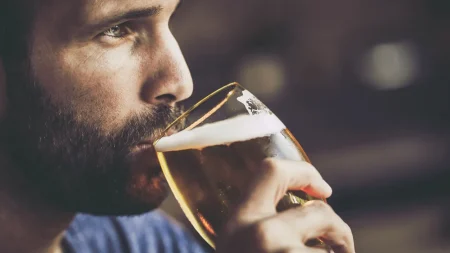 bearded man drinking beer