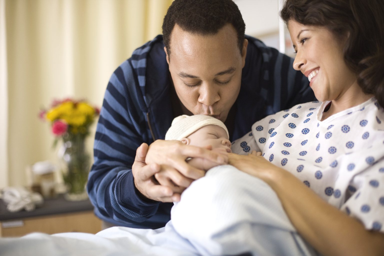 couple doting over newborn hospital