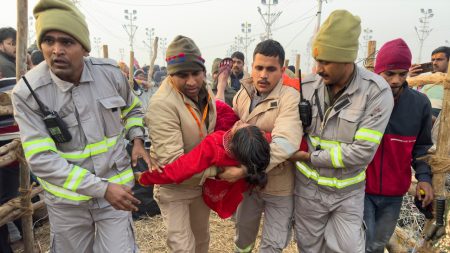 india maha kumbh festival stampede officers carry woman