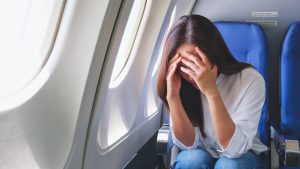 woman in pain on plane