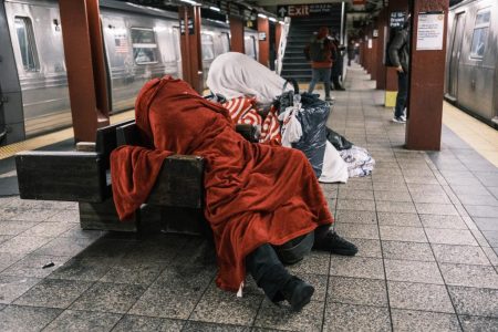 two homeless people sleep benches 96867534