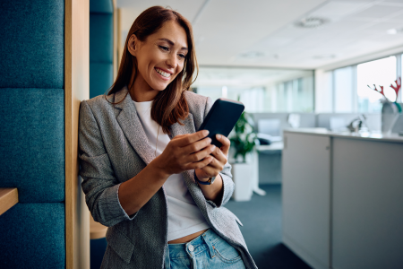 woman happy smiling office texting mobile phone