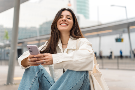 woman oversized white shirt blue jeans smiles