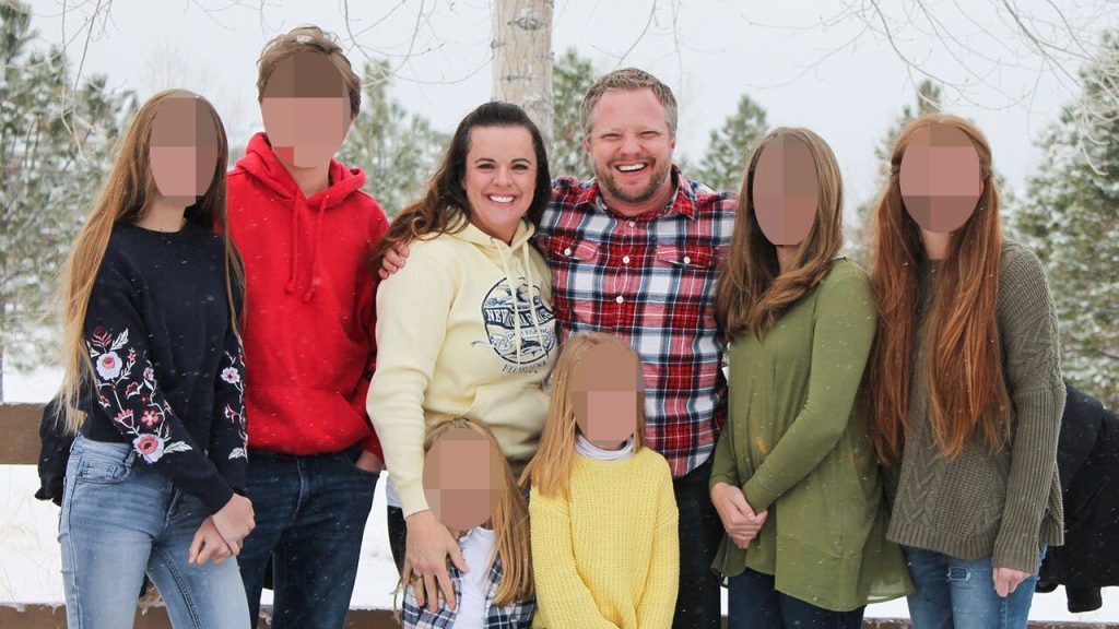 Angela and James Toliver Craig with children blurred