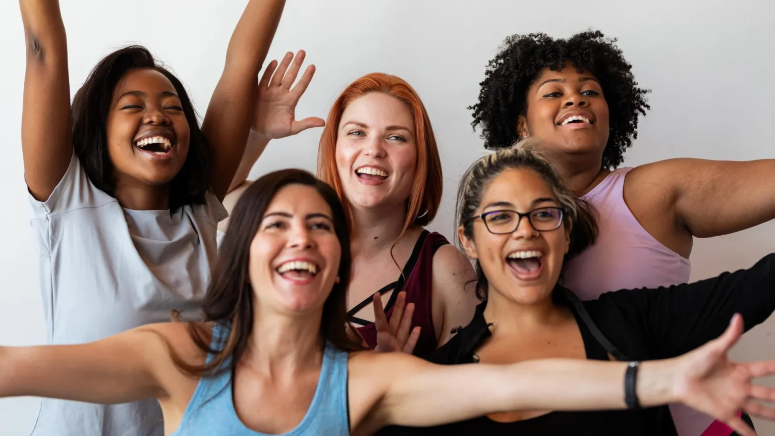 happy fit diverse women celebrating.webp