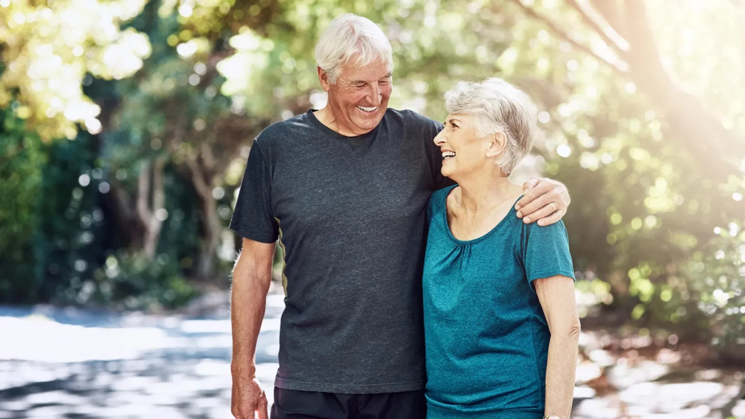 outdoor hug senior fitness couple outside.webp