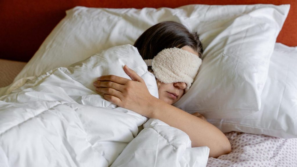 person sleeping with eye mask