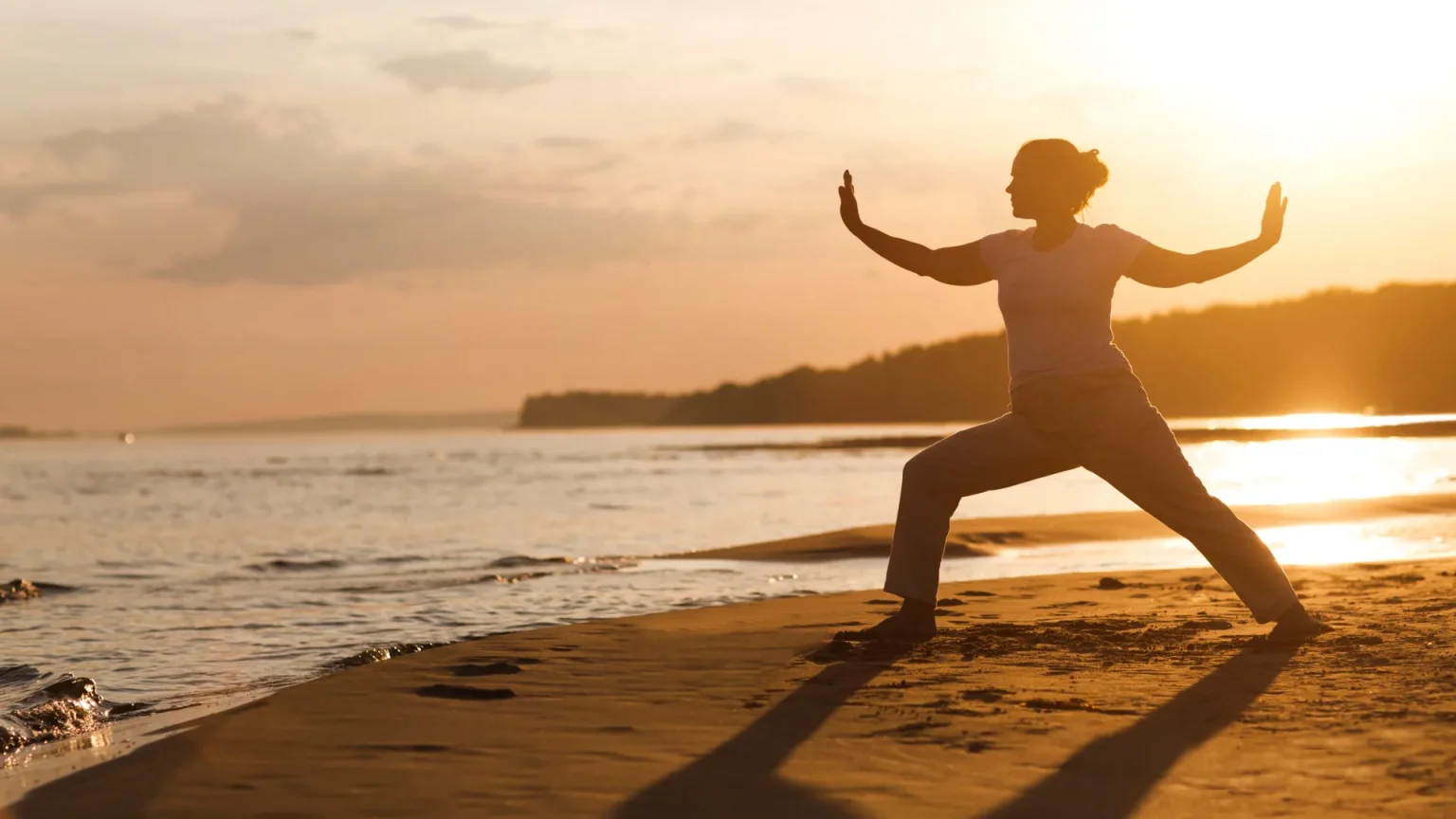 woman tai chi beach sunset.webp