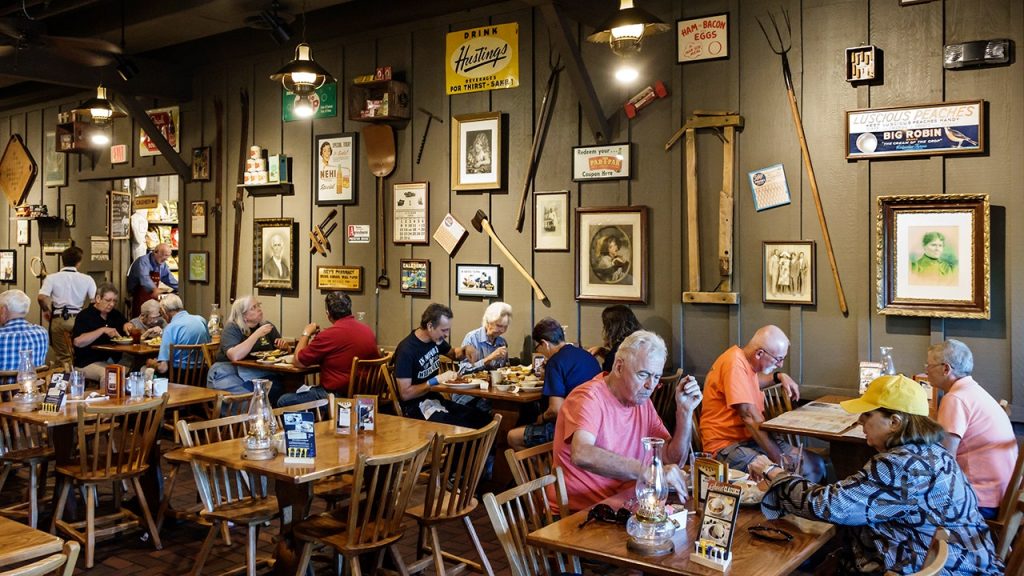 cracker barrel customers eat with antiquities on wall