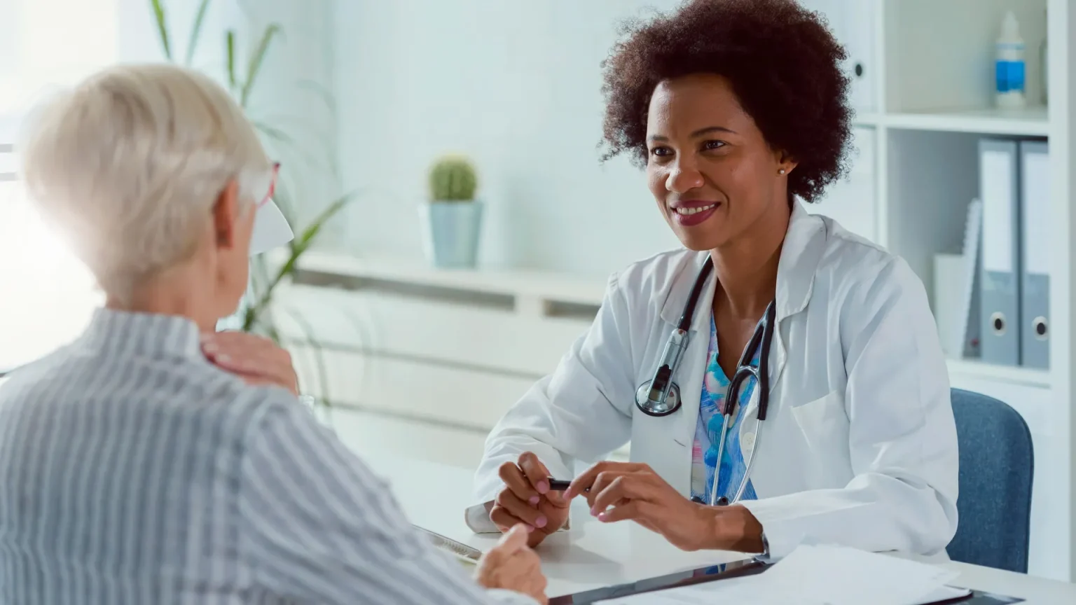 female doctor senior woman patient.webp