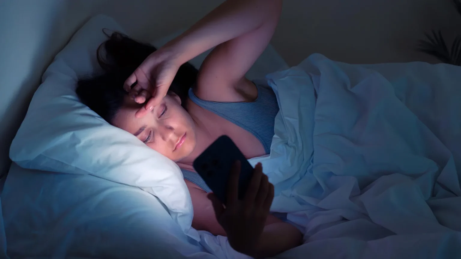 girl stress bed cell phone.webp