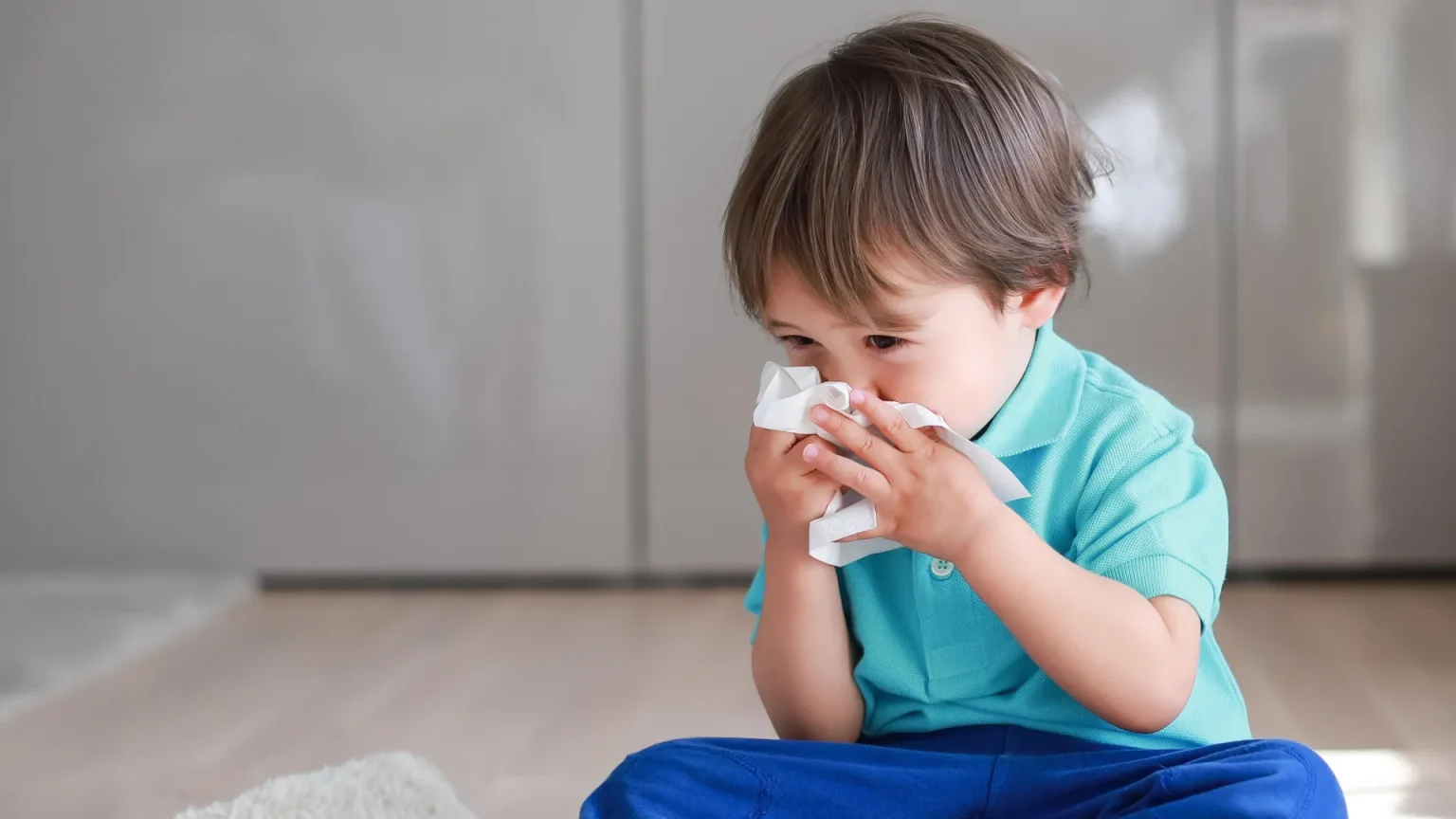 little boy sick cold blowing nose.webp