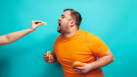 Array obesity man eating fast food.webp