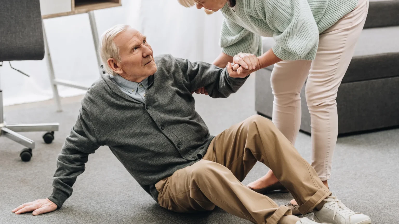 old man on floor being helped up.webp
