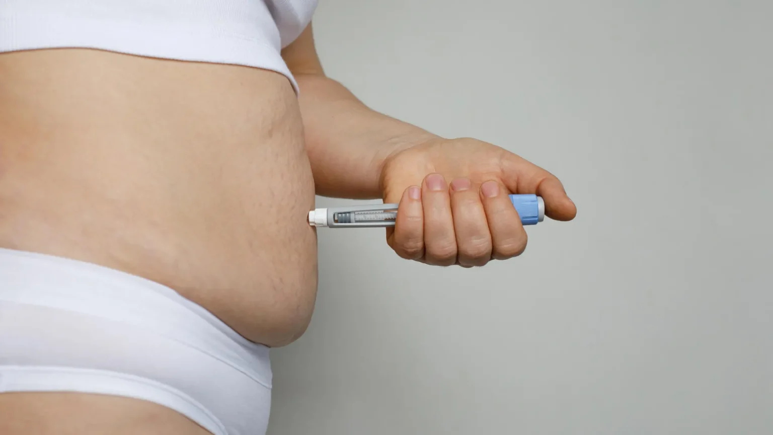 semaglutide injection pen in stomach.webp