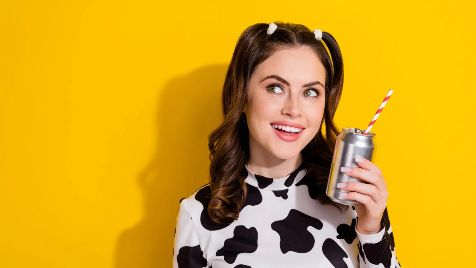 woman smiling holding diet cola.webp