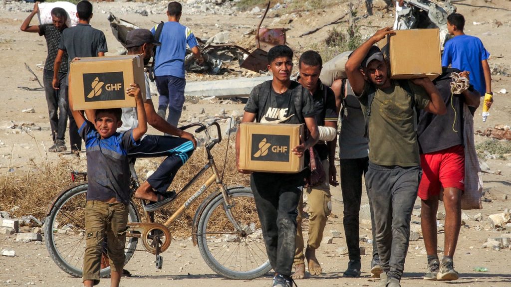 ghf gaza men carrying aid