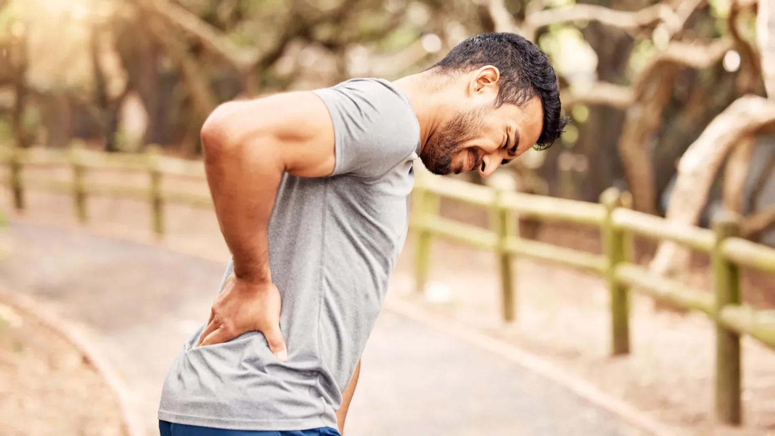 man back pain outdoors.webp