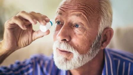 senior man eye drops.webp