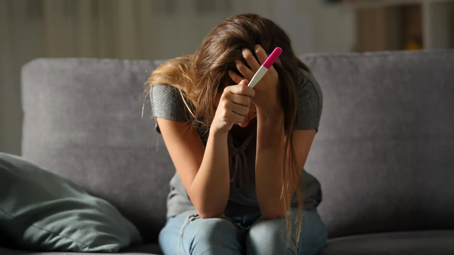young woman stressed pregnancy test.webp
